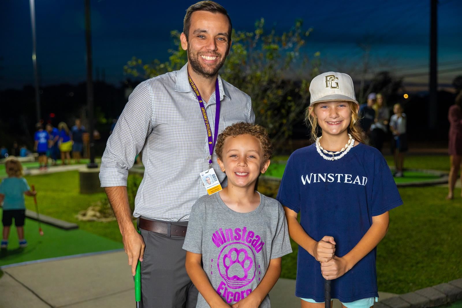 vice principal and two students at mini golf